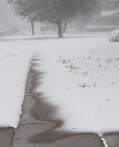 Sidewalk swallowed by snow